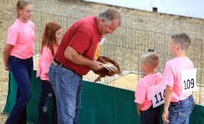 Man holding a turkey at a county fair