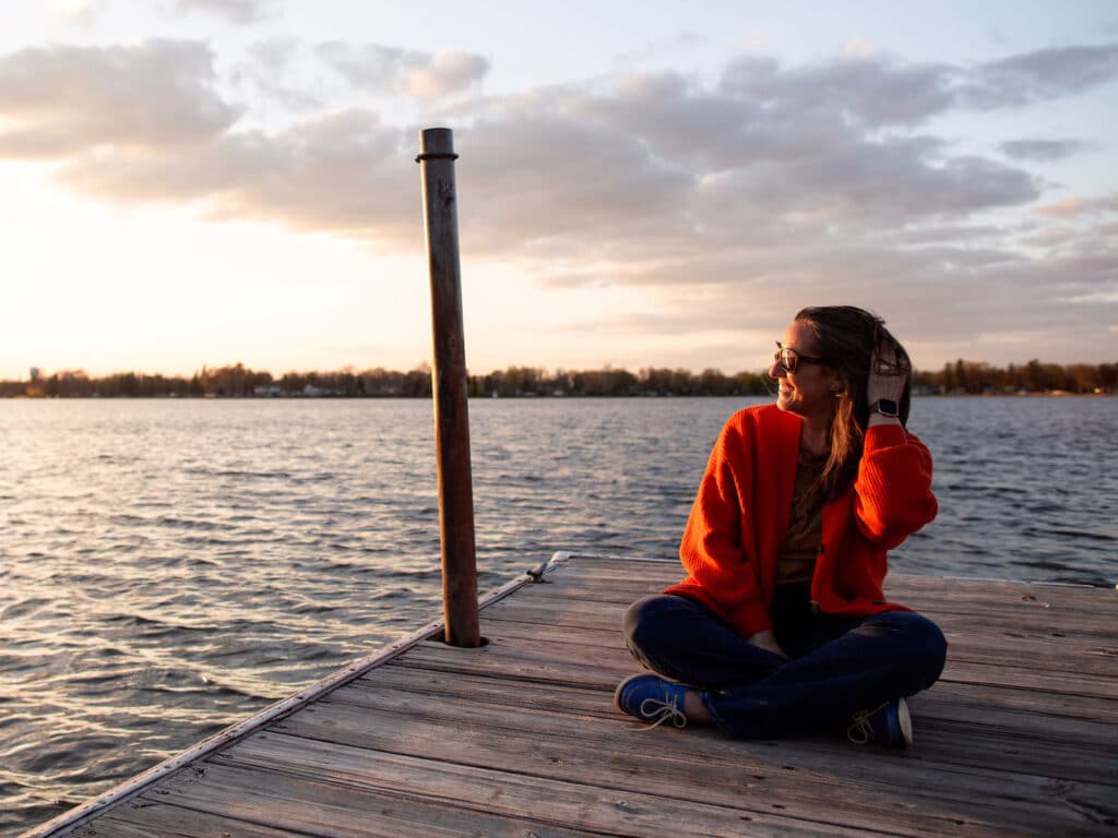 Woman siting on dock at Lake Okabena