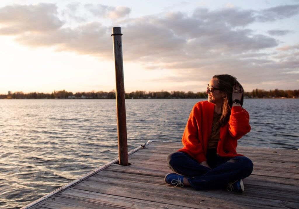 Woman siting on dock at Lake Okabena