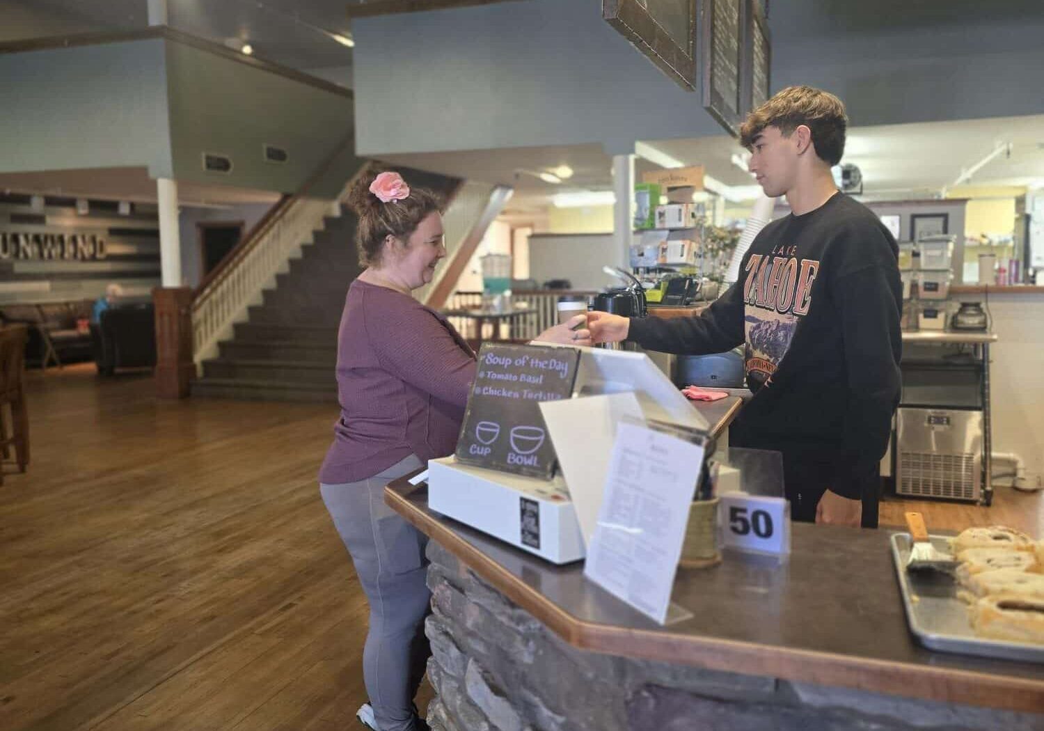 person ordering coffee at a coffee shop