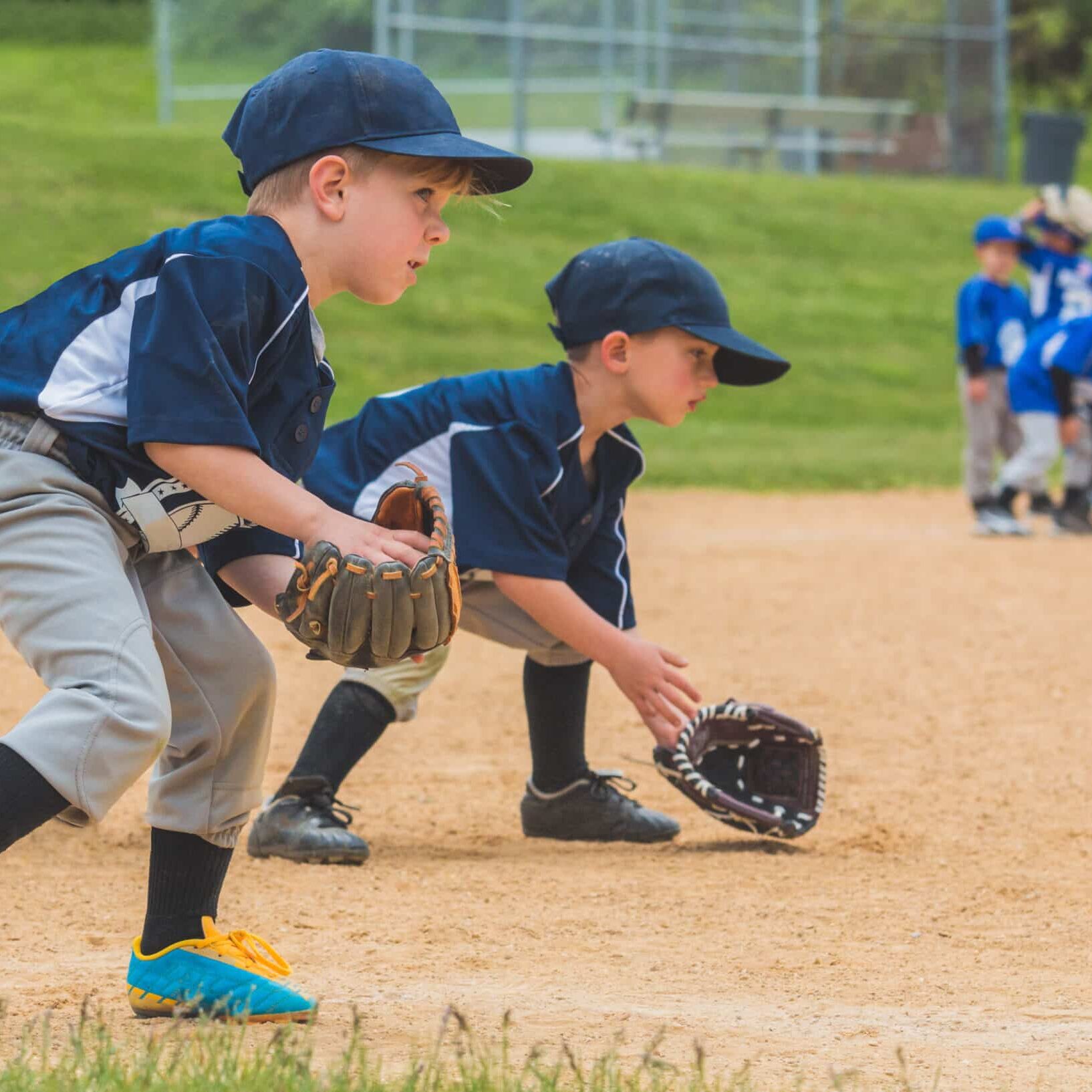 youth baseball players fielding ground balls